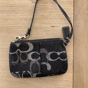 women’s black coach clutch